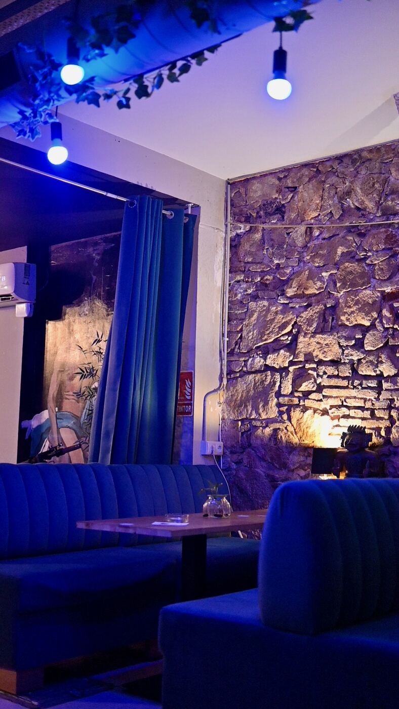 Blue velvet lounge and stone wall at Blue Dream Social Club, Barcelona
